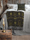 Luxurious woven cotton throw blanket featuring symmetrical scarab beetle pattern in olive green on black background with white fringe trim. Perfect for dark academia, gothic, or cottagecore decor as wall hanging or cozy throw. Mystical home gift.